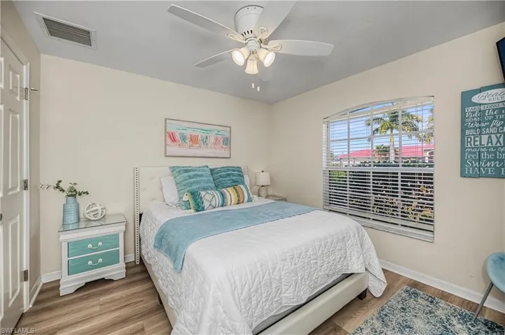 Bedroom with wood finished floors and ceiling fan
