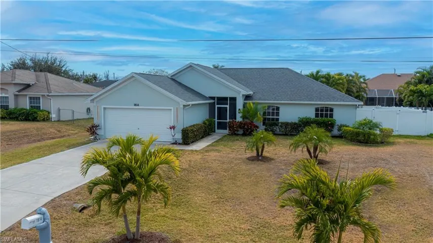 Single story home featuring stucco siding, concrete driveway, an attached garage, roof with shingles, and a sunroom