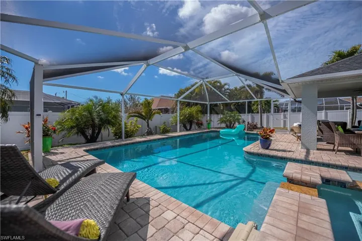 View of pool featuring a fenced backyard, patio surround, a sunroom, and a lanai
