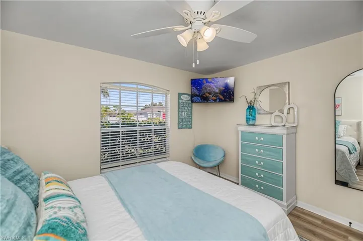 Bedroom featuring wood finished floors and a ceiling fan