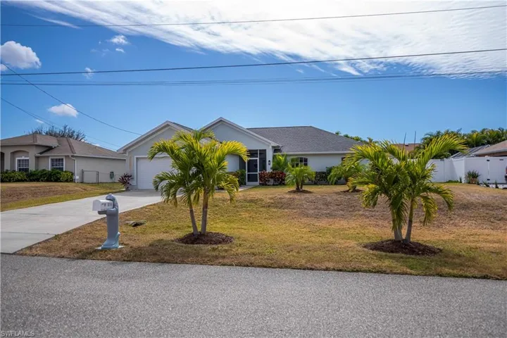 View of front of property featuring stucco siding, concrete driveway, and a garage