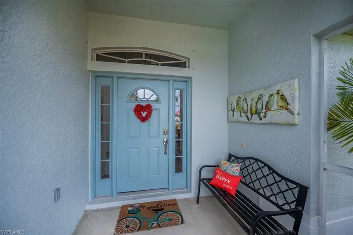 Property entrance with stucco siding and covered porch