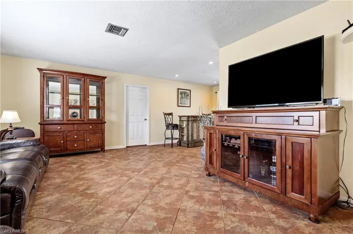 Living room with baseboards and recessed lighting
