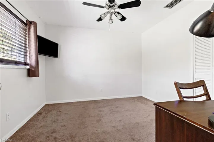 Unfurnished office with carpet and ceiling fan
