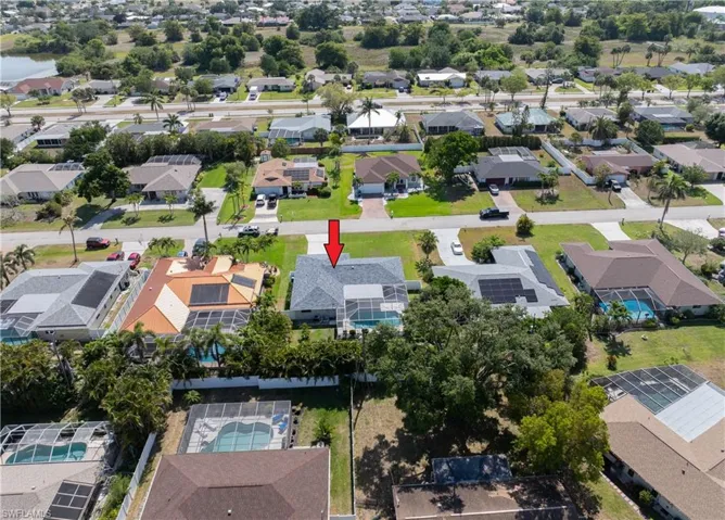 Aerial view of property's location with nearby suburban area