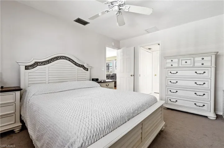 Bedroom featuring dark colored carpet and ceiling fan