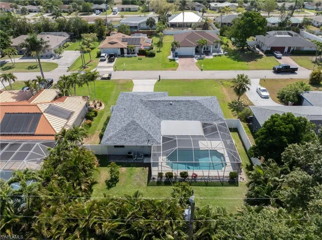 Aerial view of residential area featuring a pool