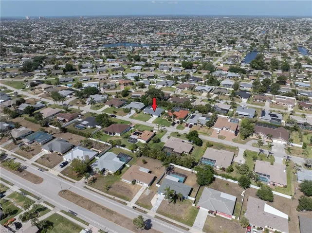 Aerial overview of property's location featuring nearby suburban area