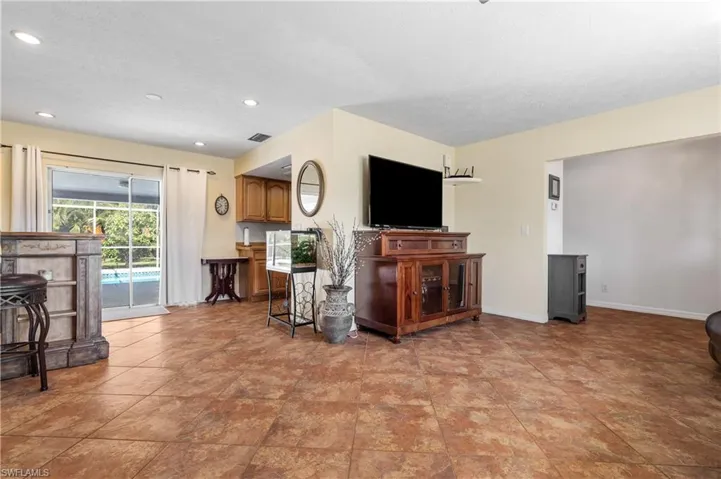 Living area featuring baseboards and recessed lighting