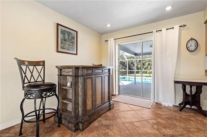Dining area with recessed lighting and a sunroom
