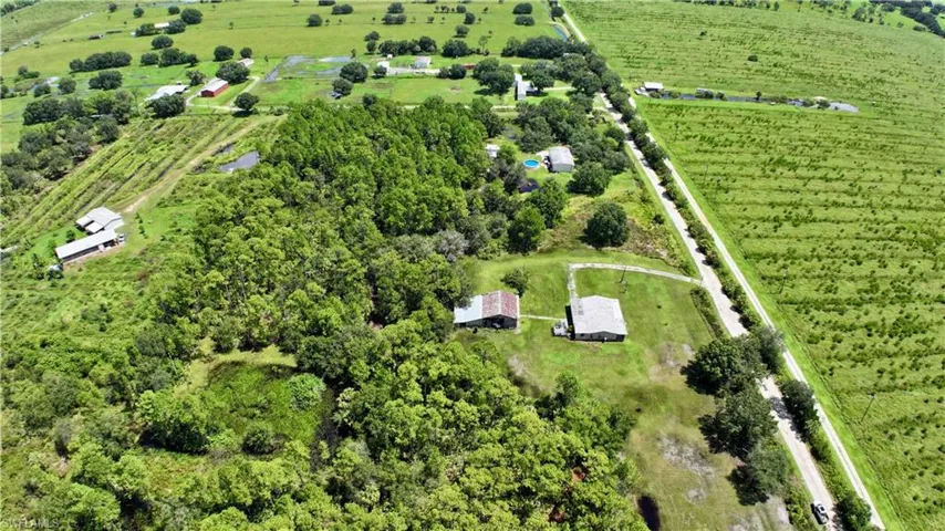 Extensive green acreage featuring multiple outbuildings and established trees