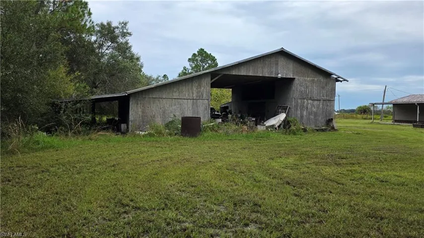 Agricultural structure featuring a partial lean-to and an open-sided shed