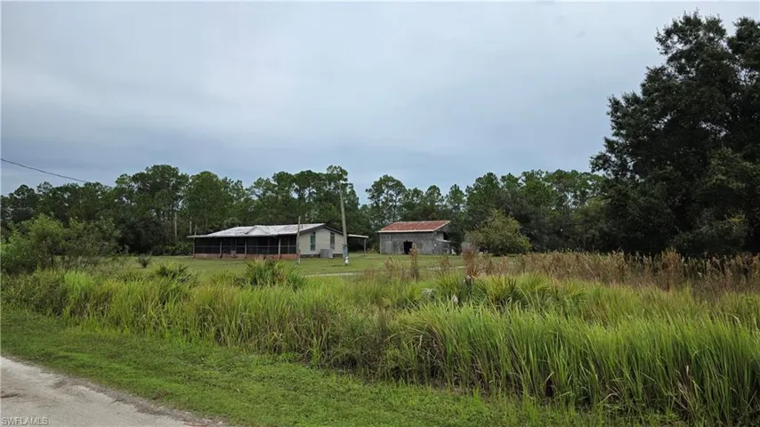 Two structures situated among natural foliage