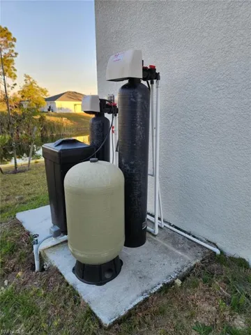 Exterior view of a water softener system and stucco siding