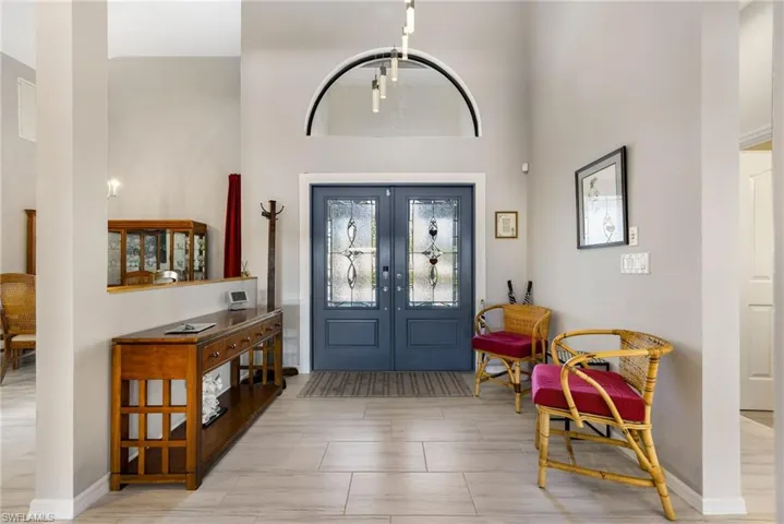 Entrance foyer featuring a towering ceiling and french doors