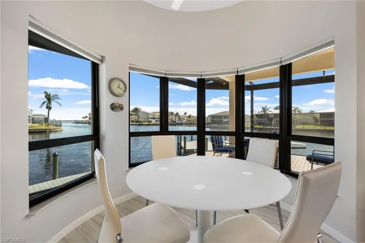 Sunroom / solarium featuring a water view