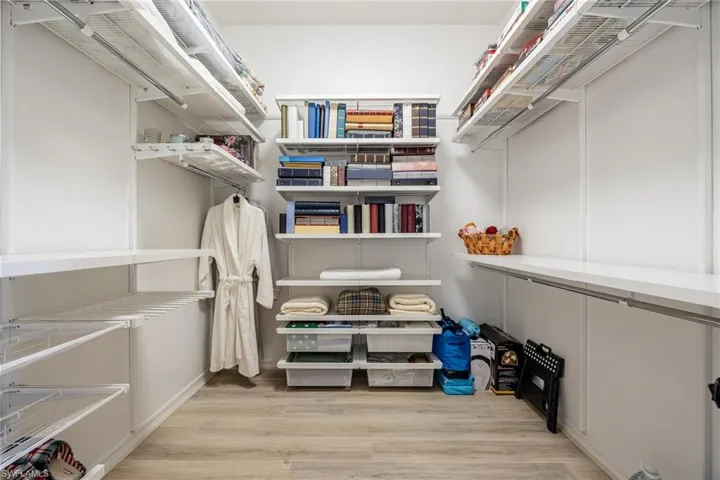 Spacious closet featuring light hardwood / wood-style flooring