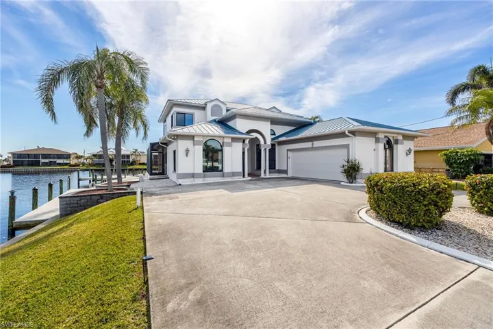 View of front facade featuring a front yard and a water view