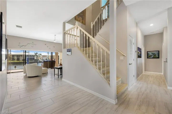 Staircase with hardwood / wood-style flooring and a water view