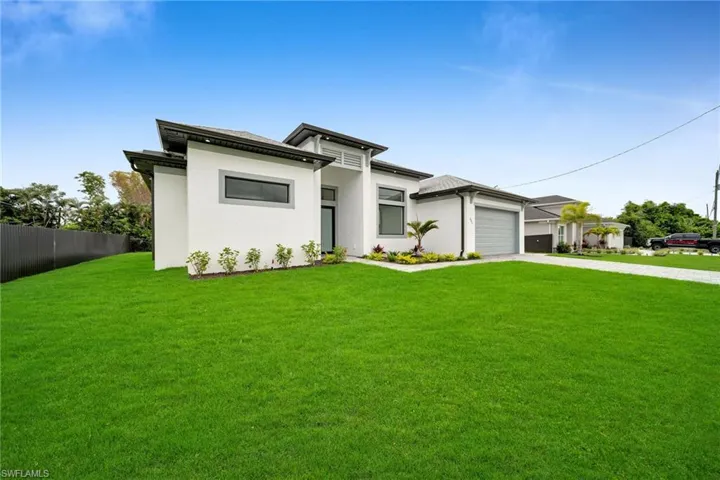 Prairie-style house featuring a front yard and a garage