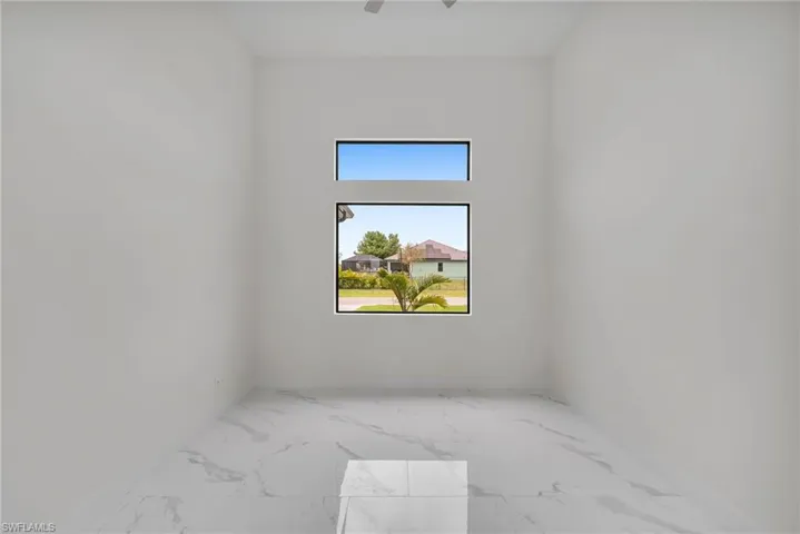 Spare room featuring light tile floors