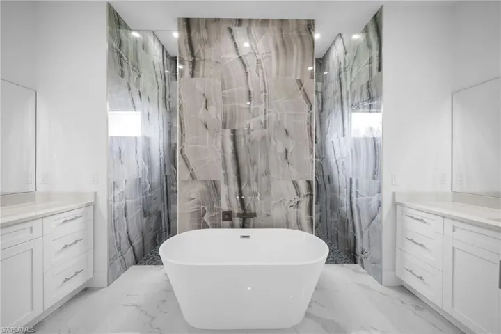 Bathroom featuring tile walls, tile floors, and vanity