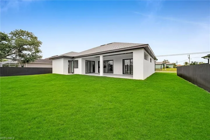 Rear view of property featuring a lawn