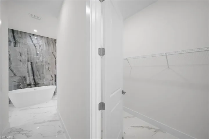 Walk in closet featuring tile floors