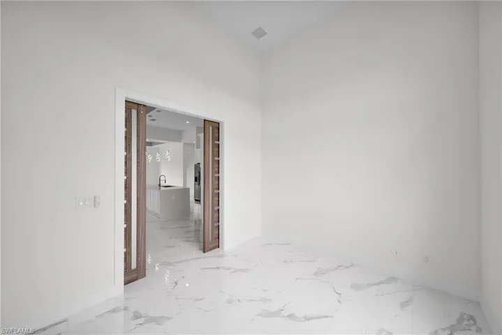 Tiled spare room featuring sink
