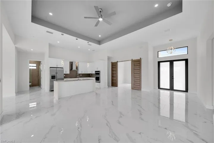 Kitchen featuring a tray ceiling and light tile flooring