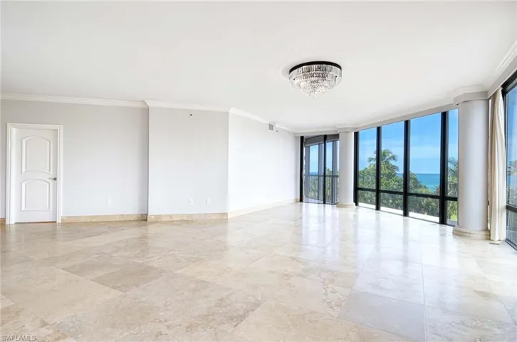 Grand living room with 9 foot ceiling and floor to ceiling glass looking from living room & dining area to SGDs to the lanai