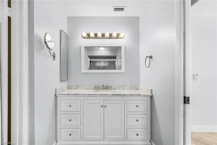 Primary Bathroom featuring vanity and baseboards- Remodeled 2020