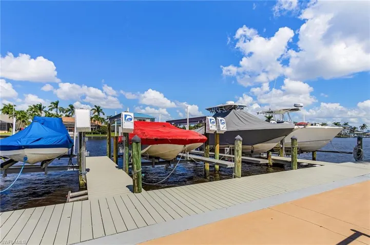 Dock area featuring boat lift and a water view
