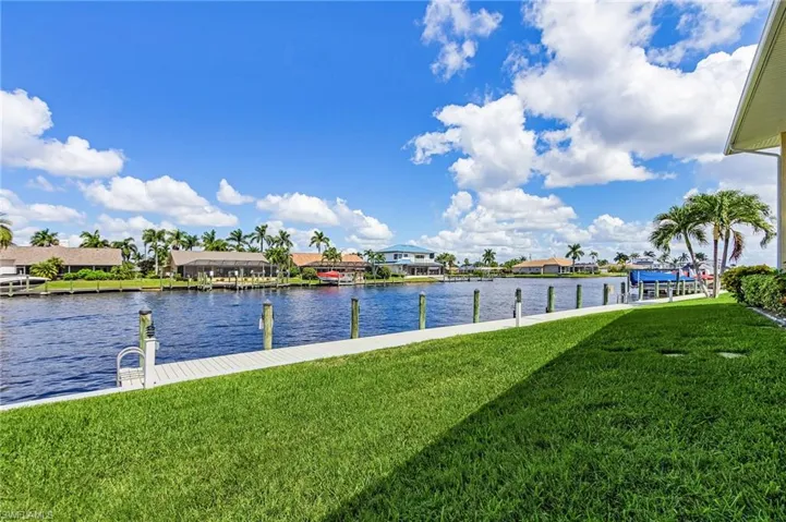 Dock with a yard, a water view, and a residential view