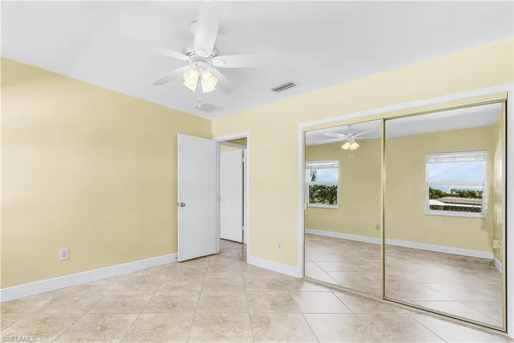 2nd Bedroom with light tile patterned floors, a ceiling fan, and a closet