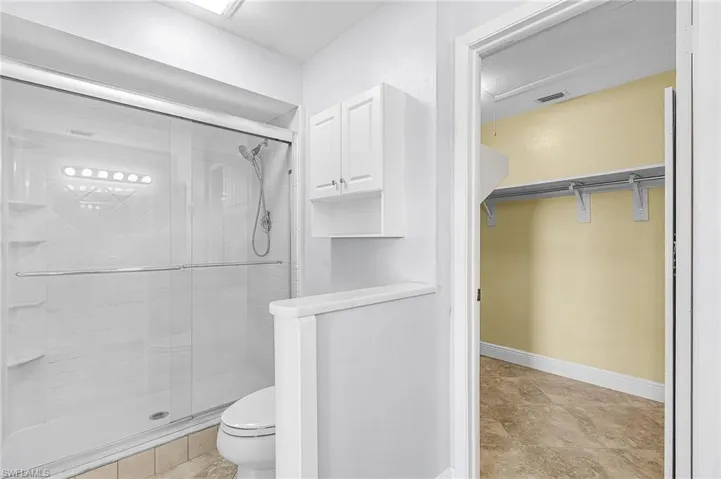 Primary Bathroom with a walk in closet and a stall shower- Remodeled 2020