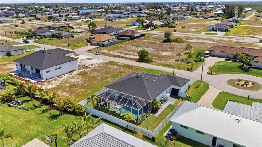 Aerial view of surrounding homes and water