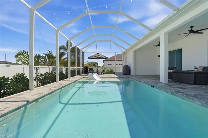Saltwater pool with paver pool deck and screen enclosure