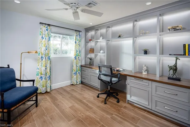 Home office featuring built in study area, light wood-style floors, recessed lighting, and ceiling fan