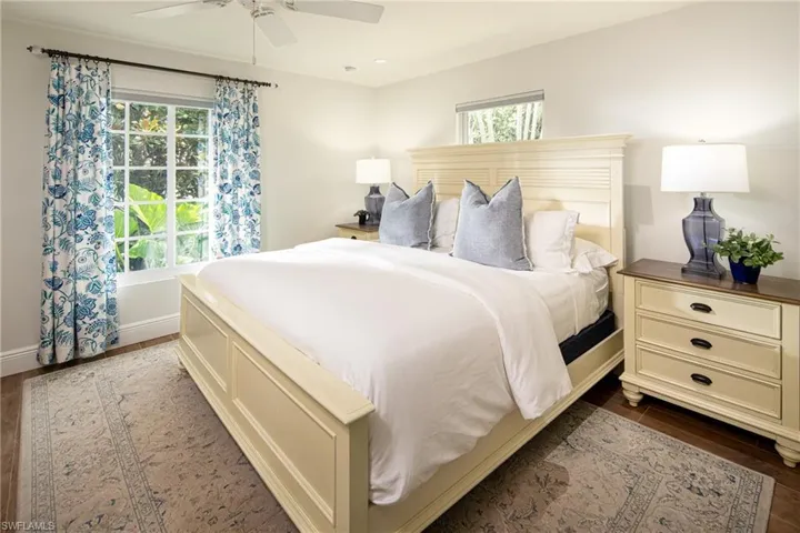Bedroom with dark wood-style floors and a ceiling fan