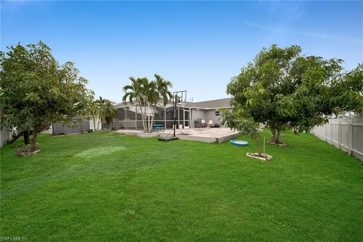 View of yard featuring a patio area, a lanai, and a swimming pool