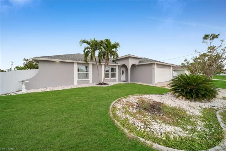 Single story home with a front yard and a garage
