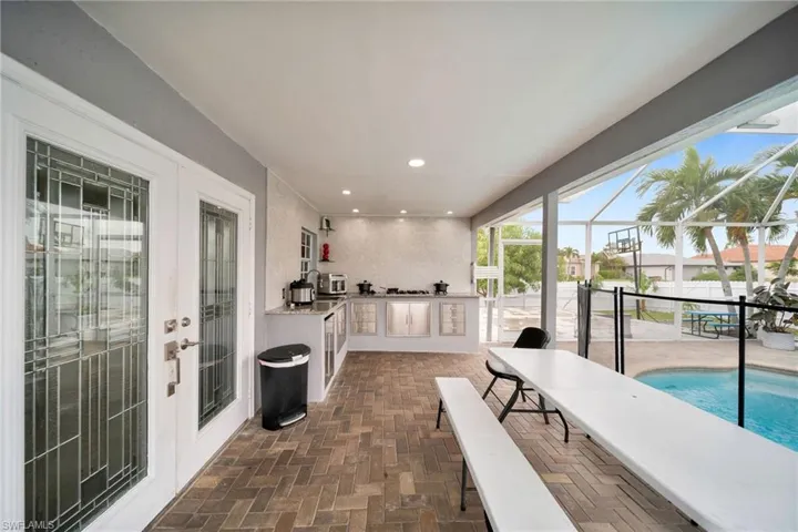 View of patio featuring a lanai and exterior kitchen