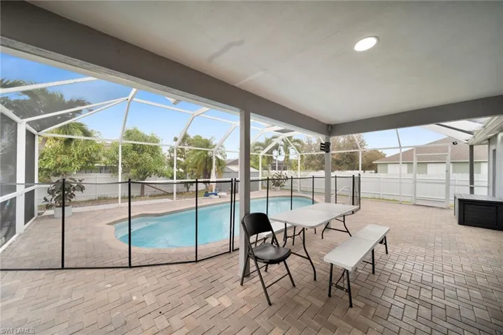 View of pool with a patio and a lanai