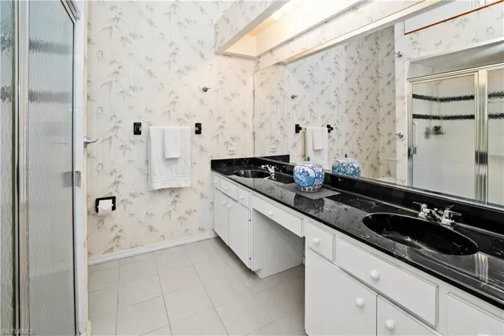 primary ensuite bath boasts dbl sinks, walk in tiled shower and lots of storage