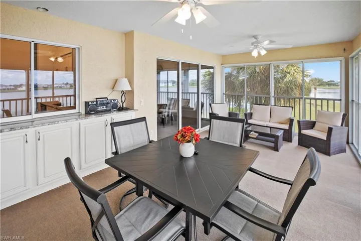 Impressive, 20ft, 4 season, screened lanai with roll down shutters and peaceful view of Lake Rio and pass thru to kitchen