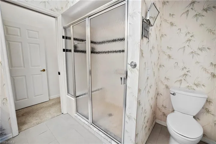 primary ensuite bath boasts dbl sinks, walk in tiled shower and lots of storage