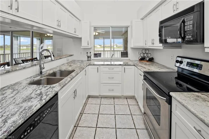 spacious kitchen with gorgeous granite and a wonderful view of the lake