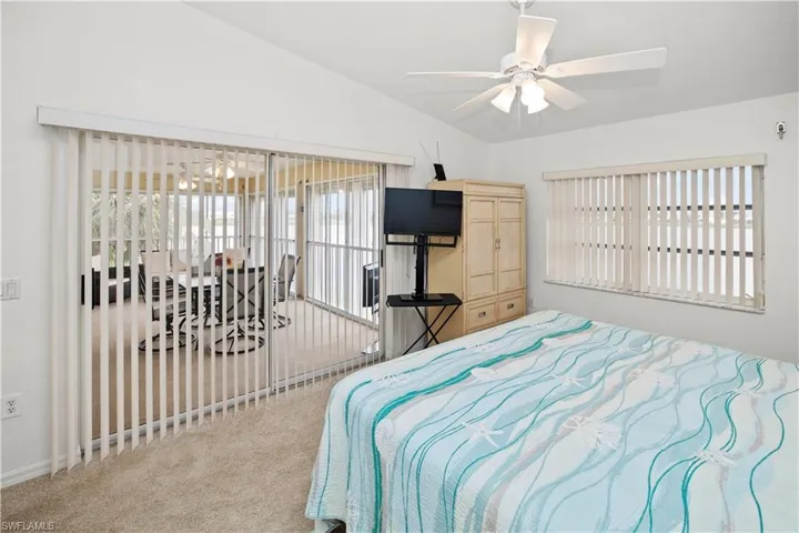 spacious 12 x 16 primary bedroom and gorgeous lake views and sliders out to the relaxing lanai