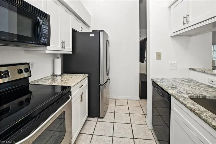 stainless appliances and lots of cabinets for storage